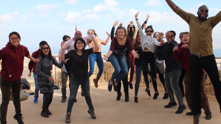 Full group picture of students jumping in the air on the Interfaith Encounter trip to Israel and Palestine.