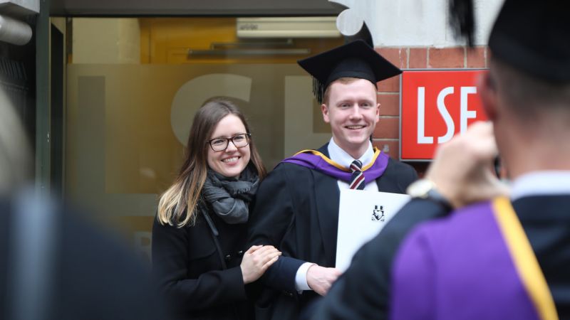 an LSE graduate posing for a photograph