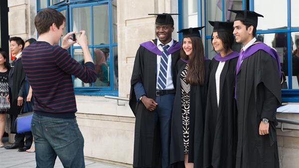 four LSE graduates posing for a photograph
