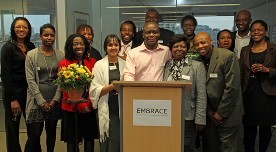 Members of EMBRACE gather and smile for the camera at an event