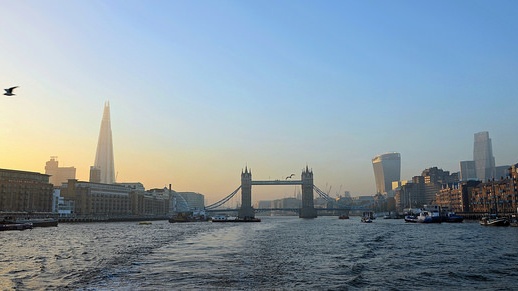 A view down the river looking at Tower Bridge at dawn