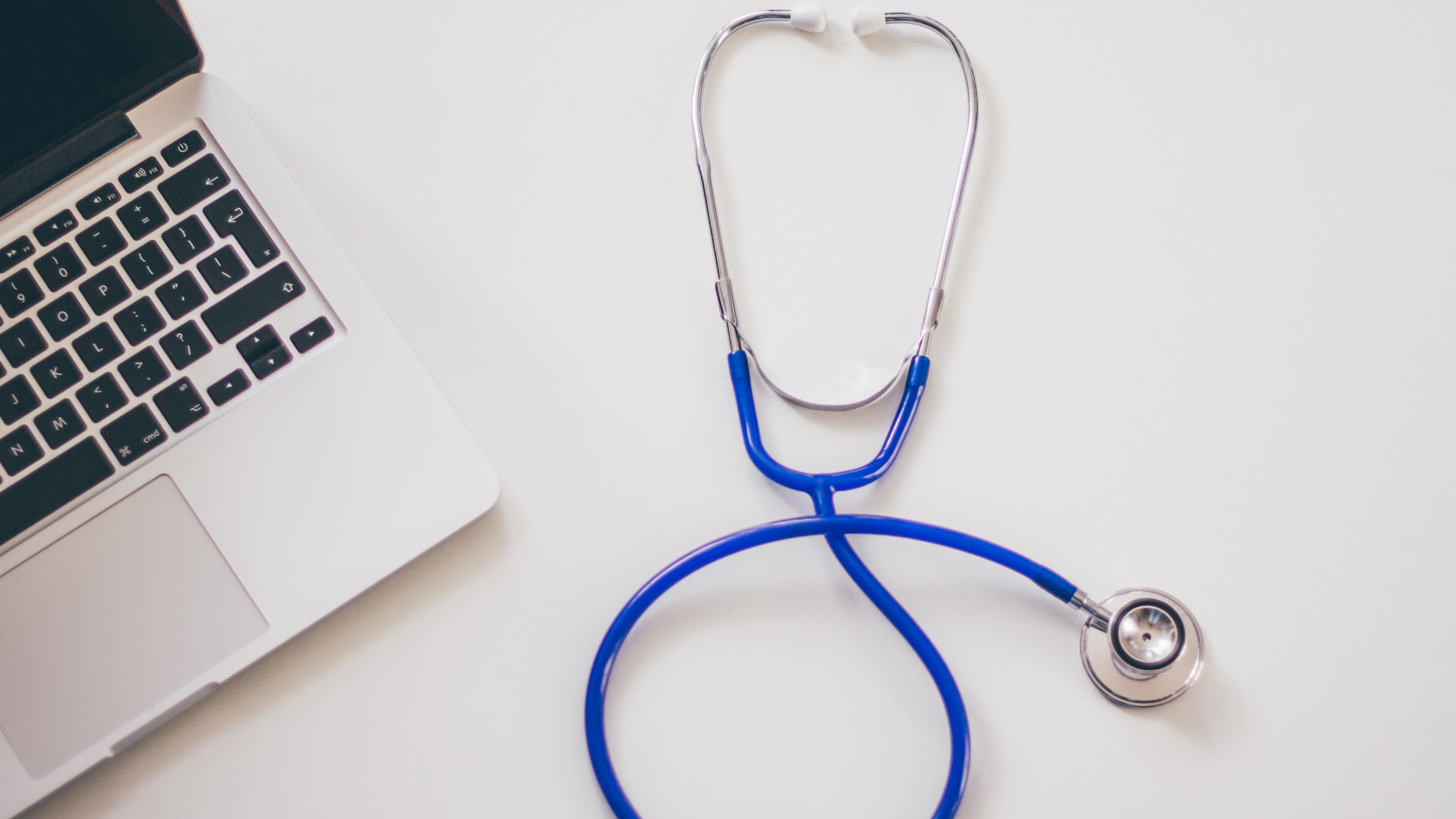 a stethoscope next to a laptop