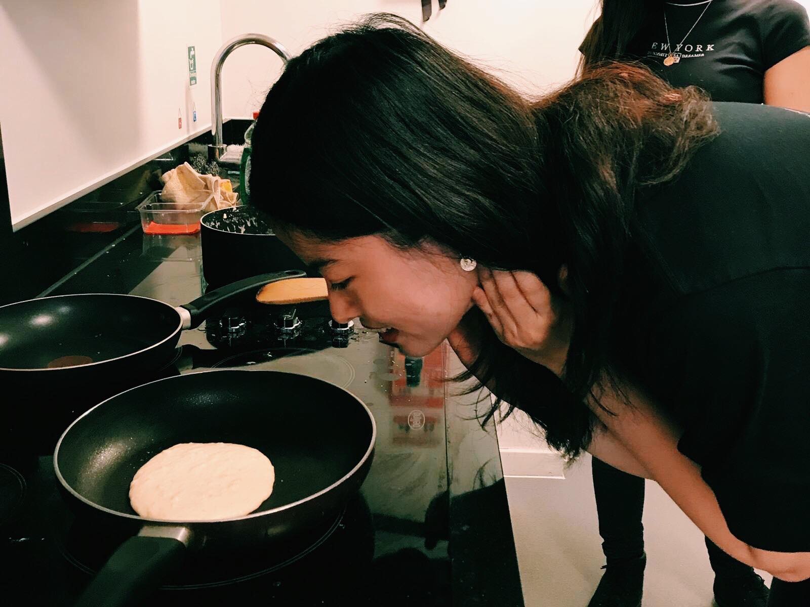 Alisha looking at a pancake in a pan