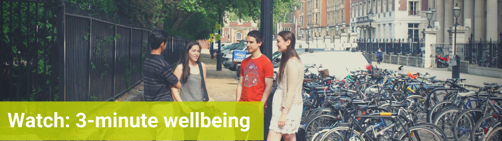 A group of students talking outside, text reads 'Watch: 3-minute wellbeing'