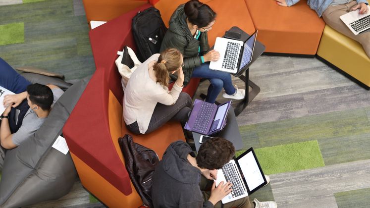 Looking down on students on sofas in the Library