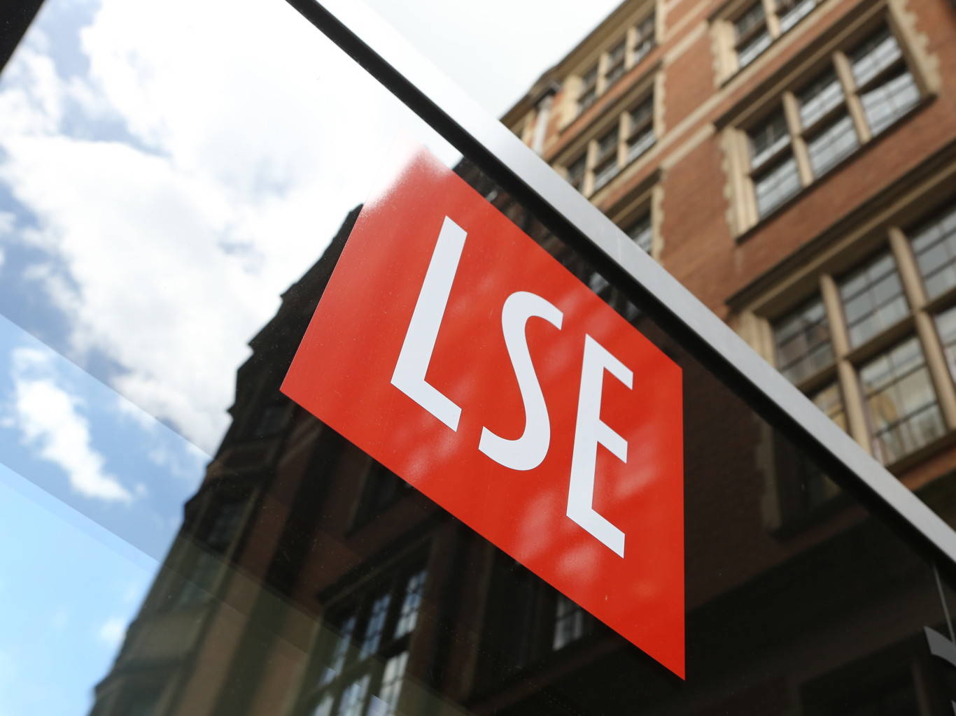 Red LSE Logo on the wall with red building in the diagonal background