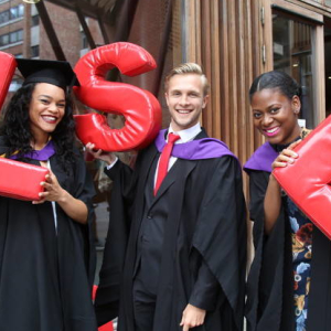 students holding LSE letters at graduation