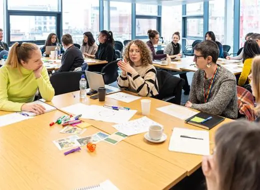 People at a table discussing practice methods