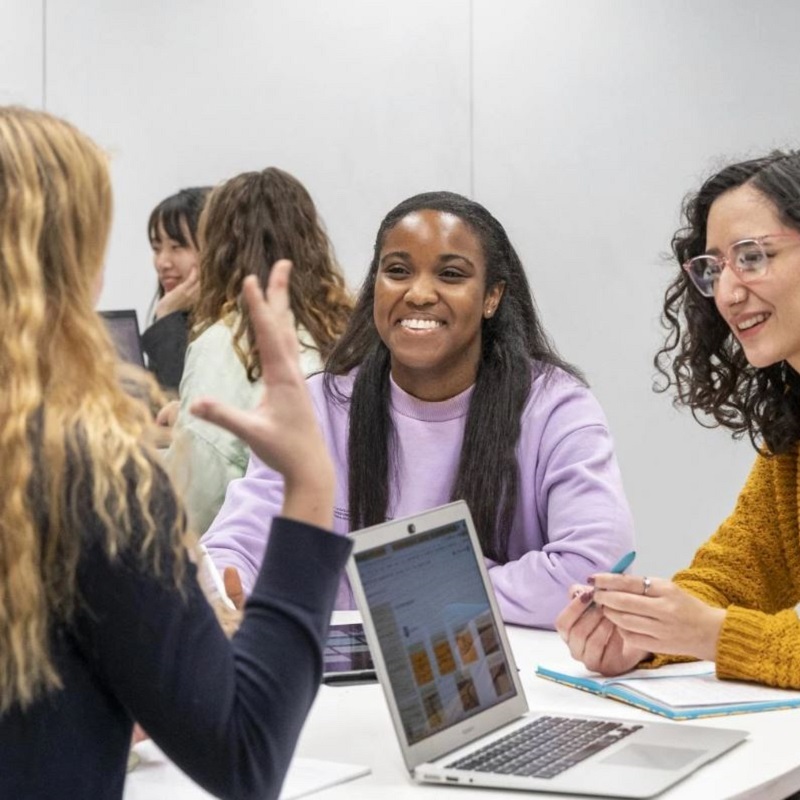 students studying at table with each other