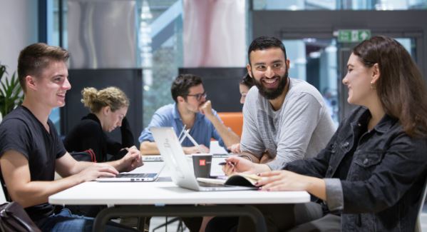students discussing a topic at a table