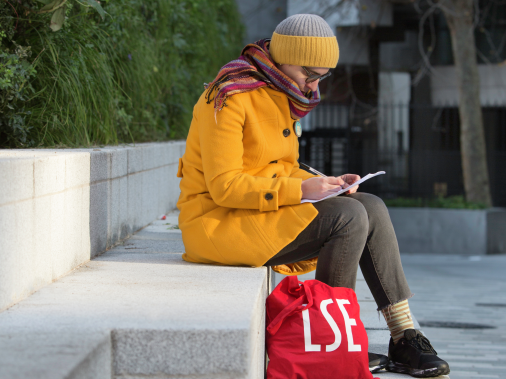 woman in yellow coat with LSE bag
