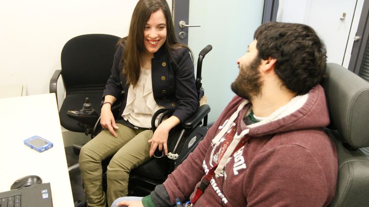 Two people in wheelchairs having a discussion