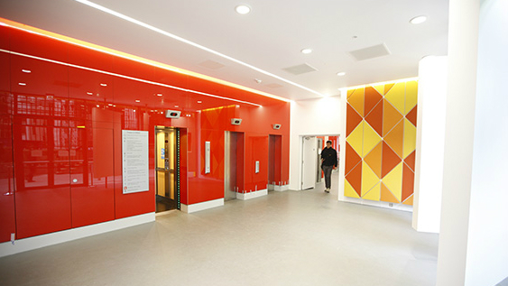 The Old Building lifts, set in a bright red wall