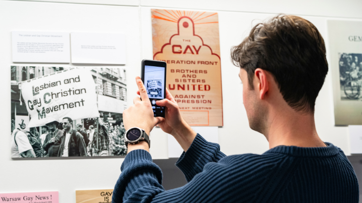 A person takes a picture of LSE Library Hall-Carpenter archival materials