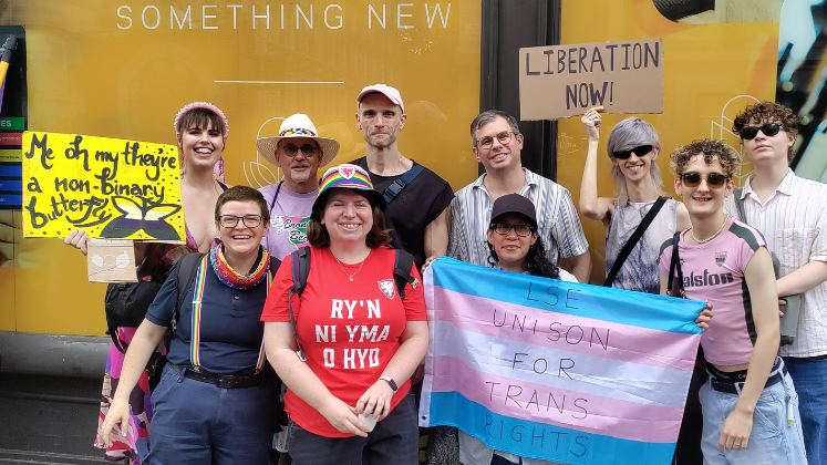 A group of Spectrum members holding posters at Trans Pride