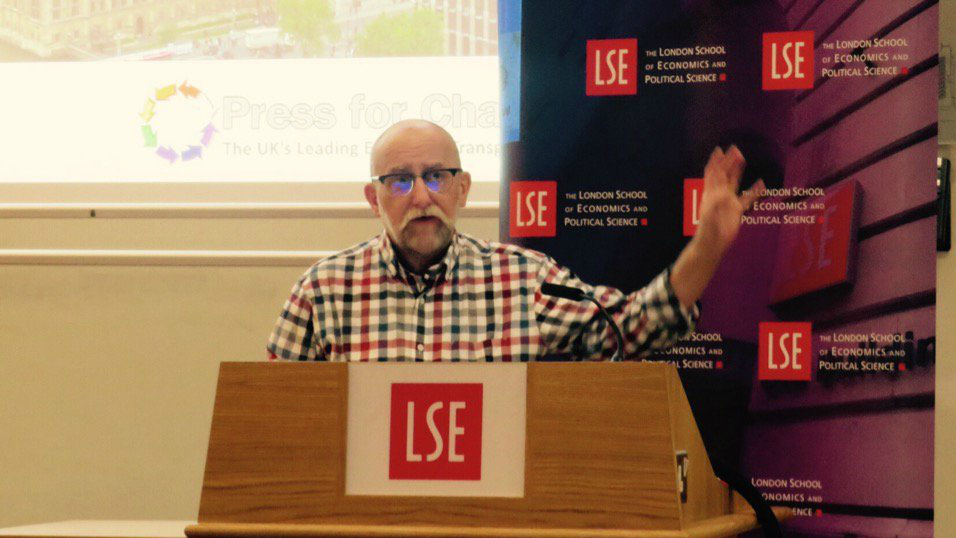 Stephen Whittle speaks from a lectern at the 'Pressing for Change: 25 years seeking trans equality' lecture